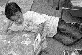 brinon Brinon relaxes while reading his book.