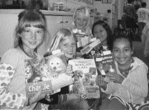 group-with-gift-books Truly, Helen, April, Litzy, and Perla proudly show off their new books, gifts from the SLO Friends of the Library.